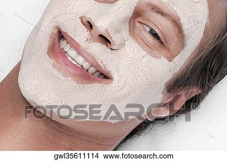 Picture - Man with face pack on his face. Fotosearch