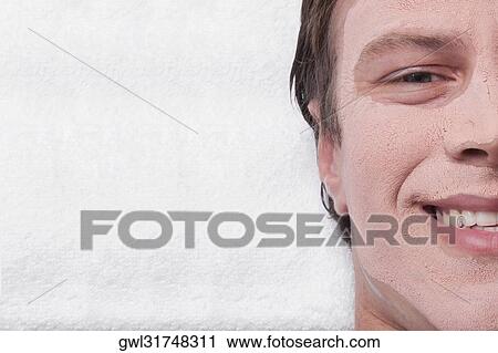 Stock Image - Man with face pack on his face. Fotosearch
