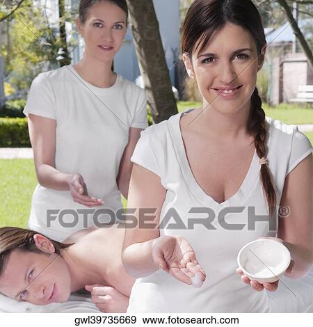Massage therapist holding a bowl of moisturizer with a man receiving back massage behind her View Large Photo Image Stock Photo - Massage therapist holding a bowl of moisturizer with a man receiving back massage behind her. Fotosearch