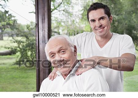 Massage therapist massaging a man's neck View Large Photo Image Stock Image - Massage therapist massaging a man's neck. Fotosearch