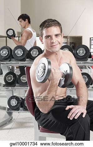 Men lifting weight at gym View Large Photo Image Picture - Men lifting weight at gym. Fotosearch