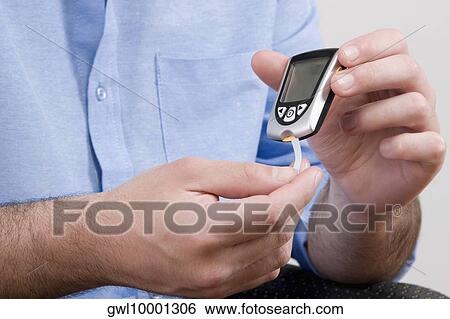 Mid section view of a male doctor demonstrating the use of a Gluco meter View Large Photo Image Stock Photograph - Mid section view of a male doctor demonstrating the use of a Gluco meter. Fotosearch
