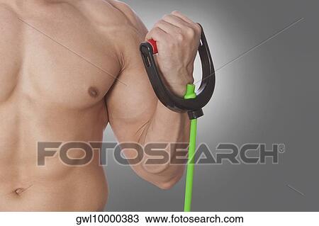 Mid section view of a man exercising with resistance band View Large Photo Image Stock Image - Mid section view of a man exercising with resistance band. Fotosearch