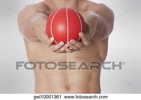 Mid section view of a man exercising with a medicine ball View Large Photo Image Stock Image - Mid section view of a man exercising with a medicine ball. Fotosearch