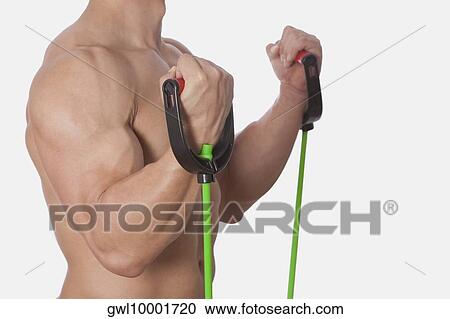 Mid section view of a man exercising with resistance band View Large Photo Image Stock Image - Mid section view of a man exercising with resistance band. Fotosearch