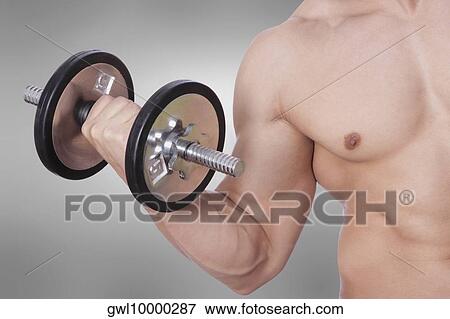 Stock Photo - Mid section view of a man exercising with a dumbbell. Fotosearch