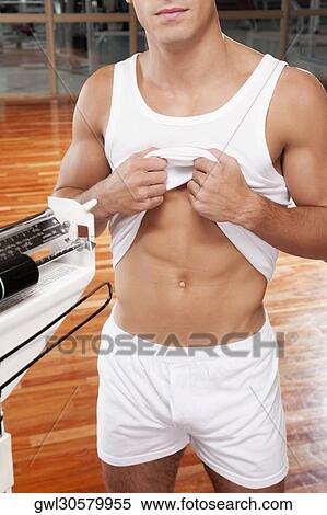 Mid section view of a man showing his waist View Large Photo Image Stock Photography - Mid section view of a man showing his waist. Fotosearch