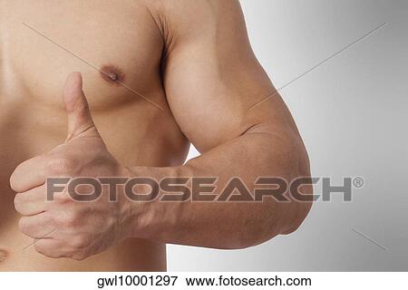 Stock Photo - Mid section view of a man showing thumbs up sign. Fotosearch