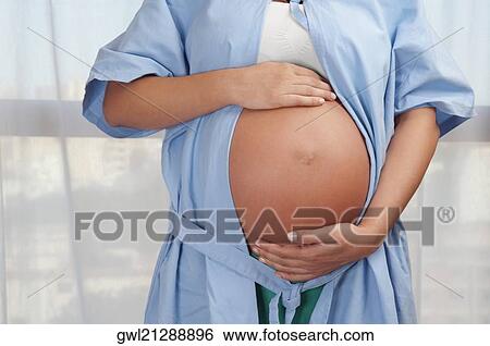 Mid section view of a pregnant woman in a hospital View Large Photo Image Stock Photograph - Mid section view of a pregnant woman in a hospital. Fotosearch