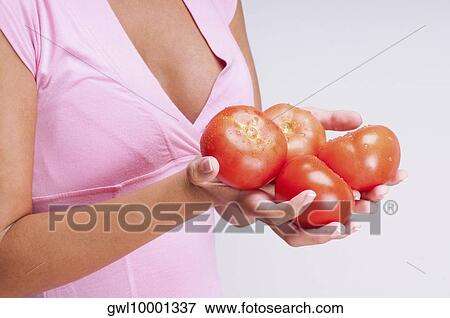 Mid section view of a woman holding tomatoes View Large Photo Image Stock Photo - Mid section view of a woman holding tomatoes. Fotosearch