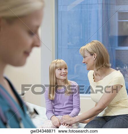 Mother sitting with her daughter in a hospital View Large Photo Image Stock Image - Mother sitting with her daughter in a hospital. Fotosearch