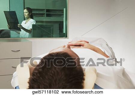 Nurse examining MRI scan of a patient View Large Photo Image Stock Image - Nurse examining MRI scan of a patient. Fotosearch