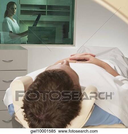 Nurse examining MRI scan of a patient View Large Photo Image Stock Photography - Nurse examining MRI scan of a patient. Fotosearch
