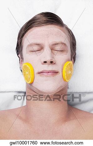Stock Image - Orange slices on a man's face. Fotosearch