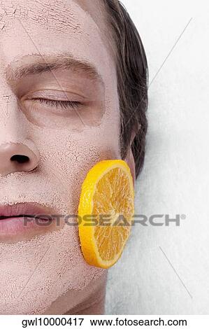 Orange slices on a man's face View Large Photo Image Stock Photo - Orange slices on a man's face. Fotosearch