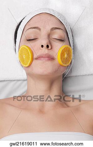 Orange slices on a woman's face View Large Photo Image Stock Image - Orange slices on a woman's face. Fotosearch