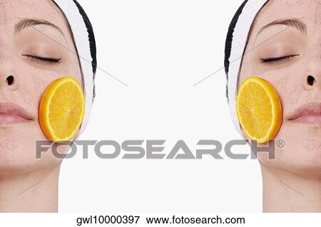 Orange slices on a woman's face View Large Photo Image Stock Photo - Orange slices on a woman's face. Fotosearch