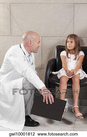 Patient and a doctor in a waiting room View Large Photo Image Stock Image - Patient and a doctor in a waiting room. Fotosearch