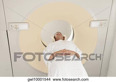 Patient going through an MRI scan View Large Photo Image Picture - Patient going through an MRI scan. Fotosearch