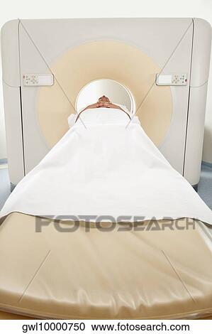 Stock Image - Patient going through an MRI scan. Fotosearch