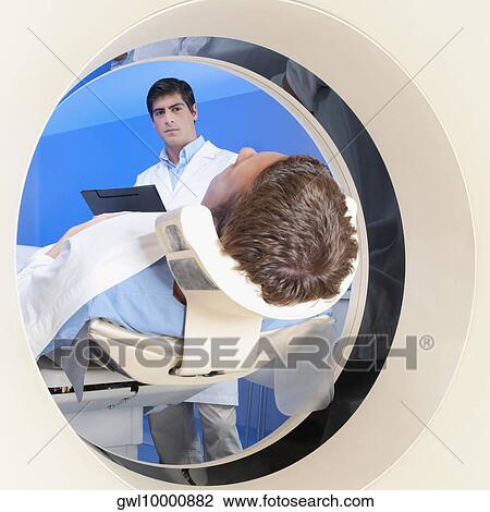 Patient going through an MRI scan View Large Photo Image Stock Image - Patient going through an MRI scan. Fotosearch