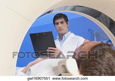 Patient going through an MRI scan View Large Photo Image Stock Image - Patient going through an MRI scan. Fotosearch