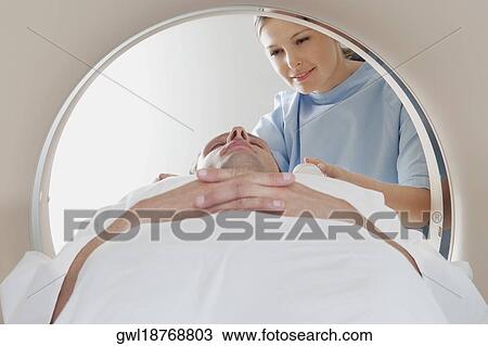 Patient going through an MRI scan View Large Photo Image Stock Image - Patient going through an MRI scan. Fotosearch