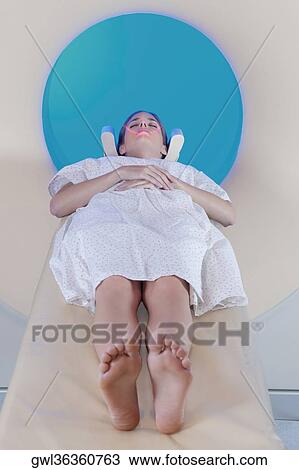 Stock Image - Patient going through an MRI scan. Fotosearch