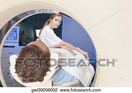 Patient going through an MRI scan View Large Photo Image Stock Image - Patient going through an MRI scan. Fotosearch
