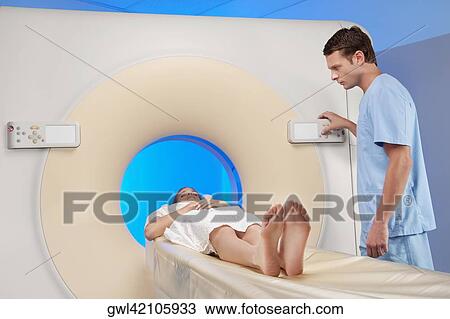 Patient going through an MRI scan View Large Photo Image Stock Image - Patient going through an MRI scan. Fotosearch