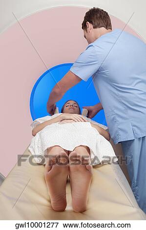Patient going through an MRI scan View Large Photo Image Stock Photo - Patient going through an MRI scan. Fotosearch