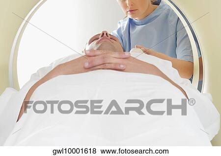 Patient going through an MRI scan View Large Photo Image Stock Photo - Patient going through an MRI scan. Fotosearch