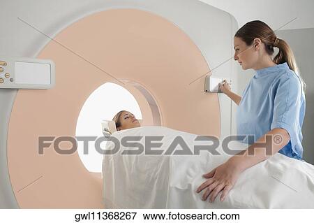 Stock Photo - Patient going through an MRI scan. Fotosearch