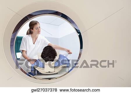 Stock Photo - Patient going through an MRI scan. Fotosearch