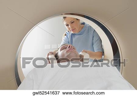 Patient going through an MRI scan View Large Photo Image Stock Photo - Patient going through an MRI scan. Fotosearch