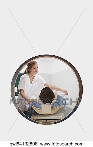 Stock Photo - Patient going through an MRI scan. Fotosearch