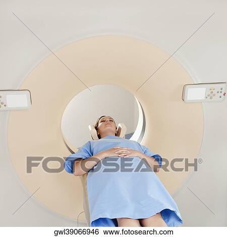 Stock Photograph - Patient going through an MRI scan. Fotosearch