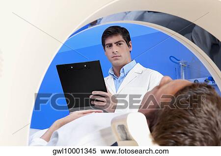 Stock Photography - Patient going through an MRI scan. Fotosearch