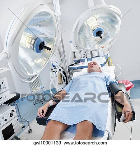 Patient lying on an operation table View Large Photo Image Stock Image - Patient lying on an operation table. Fotosearch