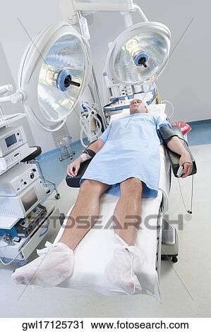 Stock Image - Patient lying on an operation table. Fotosearch