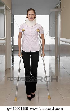 Stock Photo - Patient walking with the help of crutches. Fotosearch