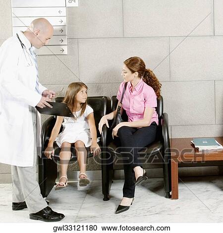 Stock Image - Patients and a doctor in a waiting room. Fotosearch