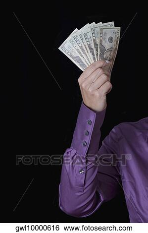 Person's hand holding fanned out currency notes View Large Photo Image Stock Photograph - Person's hand holding fanned out currency notes. Fotosearch
