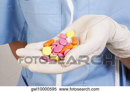 Person's hand holding pills View Large Photo Image Stock Photography - Person's hand holding pills. Fotosearch