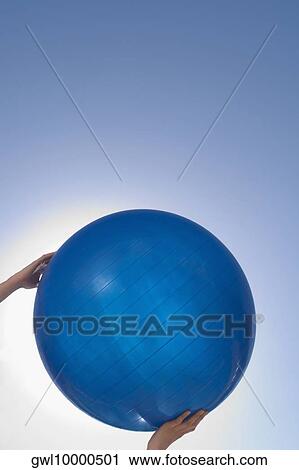 Person's hands holding a fitness ball View Large Photo Image Stock Image - Person's hands holding a fitness ball. Fotosearch