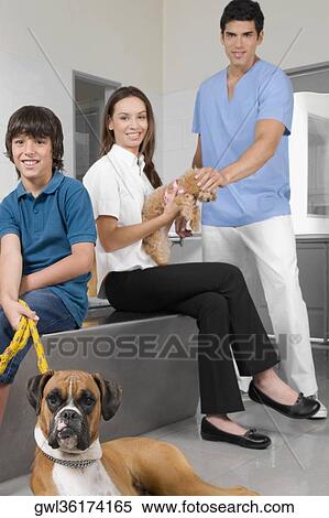 Pets with their owners in a veterinary hospital View Large Photo Image Stock Photography - Pets with their owners in a veterinary hospital. Fotosearch