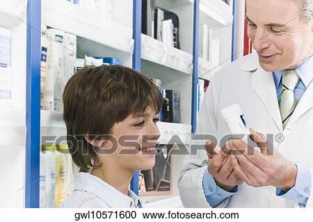 Pharmacist talking with a boy View Large Photo Image Stock Image - Pharmacist talking with a boy. Fotosearch