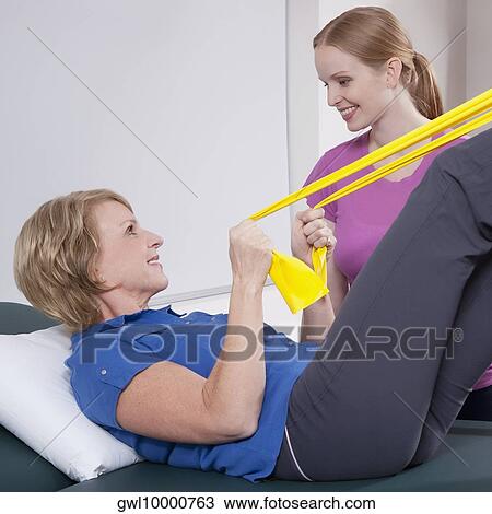 Physiotherapist assisting a patient in exercising View Large Photo Image Stock Image - Physiotherapist assisting a patient in exercising. Fotosearch