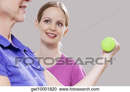 Physiotherapist assisting a patient in exercising View Large Photo Image Stock Image - Physiotherapist assisting a patient in exercising. Fotosearch