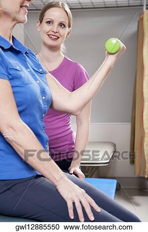 Physiotherapist assisting a patient in exercising View Large Photo Image Stock Image - Physiotherapist assisting a patient in exercising. Fotosearch